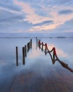 Clouds over the submerged pier at sunset