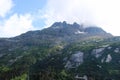 Clouds over the top of a rugged mountain in Southern Alaska Royalty Free Stock Photo