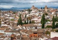 Clouds over towers and houses on cityscape of Granada. Landscape of historical town in Andalusia, Spain