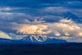 Clouds passing over mountain pinnacle in sunset light Royalty Free Stock Photo