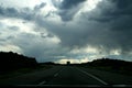 Clouds and rain over a highway in the state of utah, USA. Royalty Free Stock Photo