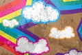 Clouds and rainbows star on cement background