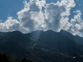 Through the clouds, the rays of the sun break through the mountains. Rosa Khutor Royalty Free Stock Photo