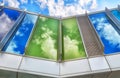 Clouds reflected on different coloured glass windows. Royalty Free Stock Photo