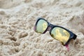 Clouds reflected in sunglasses on the beach Royalty Free Stock Photo