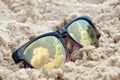 Clouds reflected in sunglasses on the beach Royalty Free Stock Photo