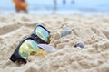 Clouds reflected in sunglasses on the beach Royalty Free Stock Photo