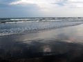 Clouds are reflected in surf waves Royalty Free Stock Photo