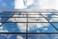 Clouds reflected in windows of modern office building Royalty Free Stock Photo