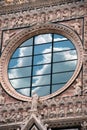 Clouds reflecting on church window in Italy