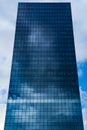 Clouds reflecting in glass of a high office building, sky scraper. Royalty Free Stock Photo