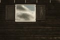 Clouds reflecting in opened old fashioned traditional wood window, Amsterdam, The Netherlands