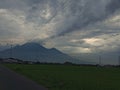 clouds, rice fields and mountains on a quiet road and cool breeze Royalty Free Stock Photo