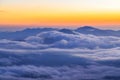 Clouds rolling over the mountains tops at sunrise Royalty Free Stock Photo