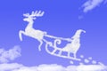 Clouds shaped Santa Claus driving in a sledge on blue sky Royalty Free Stock Photo