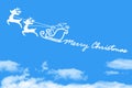 Clouds shaped Santa Claus driving in a sledge on blue sky Royalty Free Stock Photo