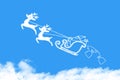 Clouds shaped Santa Claus driving in a sledge on blue sky Royalty Free Stock Photo