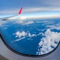 Clouds and sky as seen through window of an aircraft Royalty Free Stock Photo