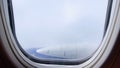 Clouds and sky as seen through window of an aircraft. Concept flying and traveling, view from airplane window on the