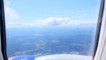 Clouds and sky as seen through window of an aircraft. Concept flying and traveling, view from airplane window on the