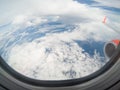 Clouds and sky as seen through window of an aircraft. Royalty Free Stock Photo