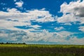 Clouds in the sky are floating over the field Royalty Free Stock Photo