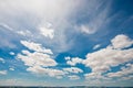 Clouds on sky with low horizon, wide shot or blue sky during sun Royalty Free Stock Photo