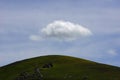 Clouds in sky sit on top of a remote hillside in Victoria, Australia.