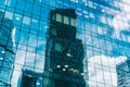 Clouds and skyscrapers are reflected in the windows of the glass building of the modern business center. Royalty Free Stock Photo