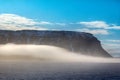 Clouds slide over from glacier and cliff to sea Royalty Free Stock Photo