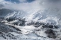 Clouds in the snowy alps Royalty Free Stock Photo