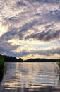 Clouds and sun at the dramatic sky over the lake