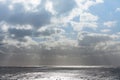 Clouds with sun rays on the ocean Royalty Free Stock Photo