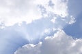 Clouds and sun shines through rays of light in the illuminated picturesque sky Royalty Free Stock Photo