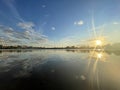 Clouds in the sunset city lake mirror