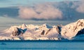 Clouds and sunset light over snow-capped mountains and icebergs, Antarctic Peninsula