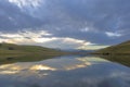 Clouds at sunset reflect on water Royalty Free Stock Photo