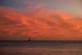 Clouds at sunset with sailboat Royalty Free Stock Photo