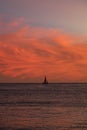 Clouds at sunset with sailboat Royalty Free Stock Photo