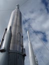 Clouds Swirl Behind Silver Rocket