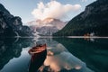 Clouds is on the top. Wooden boat on the crystal lake with majestic mountain behind. Reflection in the water. Chapel is Royalty Free Stock Photo