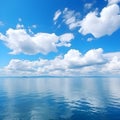 cloudscape. clouds in blue sky and reflection in a large lake. White cumulus clouds in sky over blue sea water landscape, big Royalty Free Stock Photo