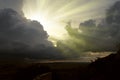 Cloudscape image of dark stormy clouds in blue sky with sun beam. The rays of the sun after the rain. Scenery with the sun`s rays Royalty Free Stock Photo