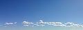 Cloudscape panorama of deep blue sky, clouds on horizon