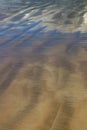 Cloudscape reflected in wet ripples of sand at Makorori Beach, Gisborne,  New Zealand Royalty Free Stock Photo