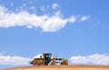 Cloudscape and road grader Royalty Free Stock Photo