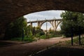 Cloudscape of St. George\'s Bridge in Alcoy framed under bridge in riverfit Royalty Free Stock Photo