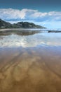 Cloudscapes reflected in wet sand on Makorori Beach, Gisborne, New Zealand