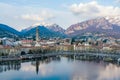 Cloudy aerial cityscape of Lecco town on spring evening. Picturesque waterfront of Lecco town located between famous Lake Como and Royalty Free Stock Photo