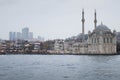 Old power meets new power in form of mosque and skyscrapers. View from the river on cloudy and foggy day.